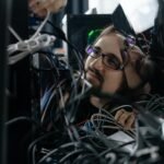 Technician troubleshooting network cabling for CCTV system