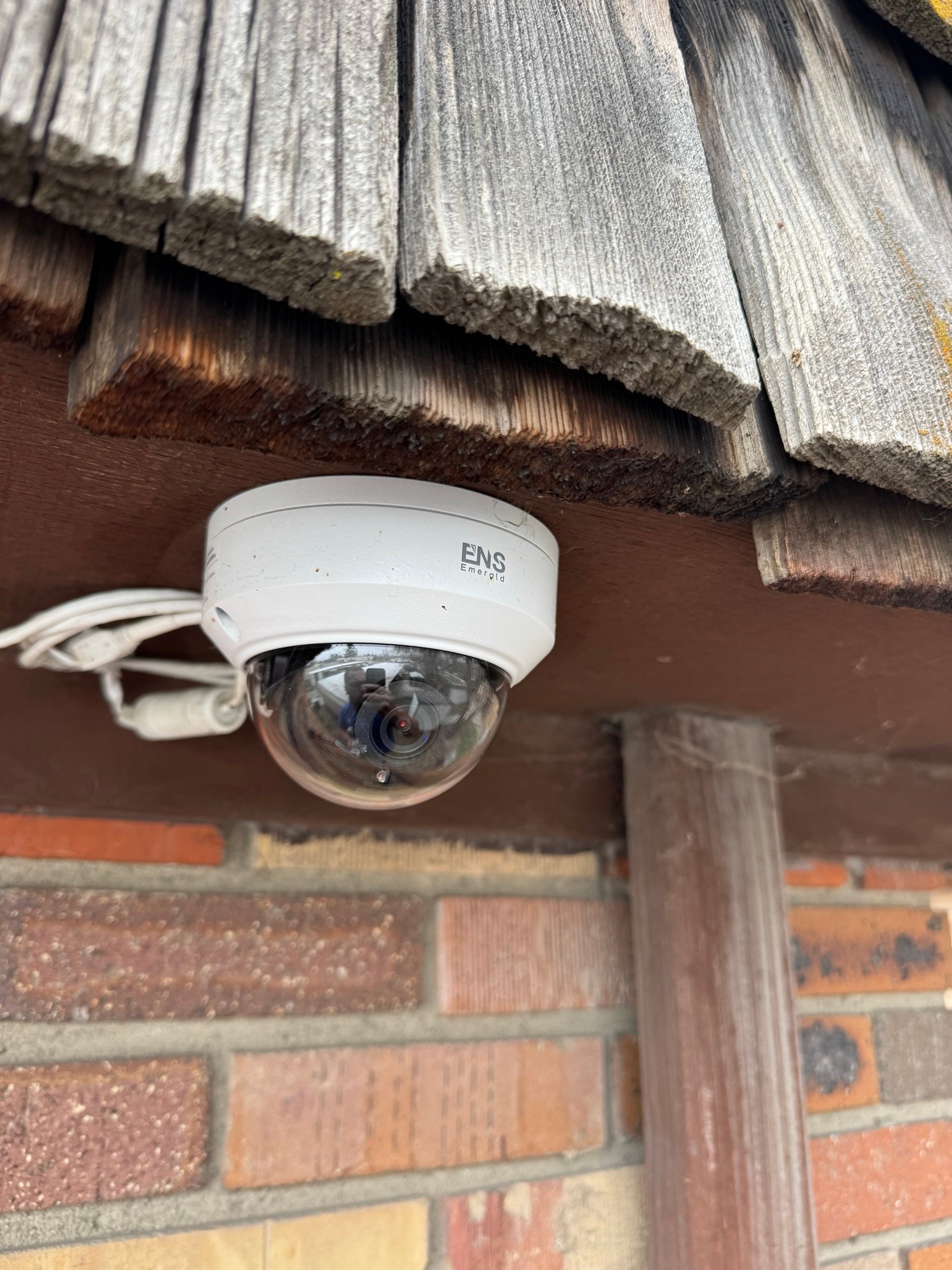 ENS Emerald dome camera on brick building exterior